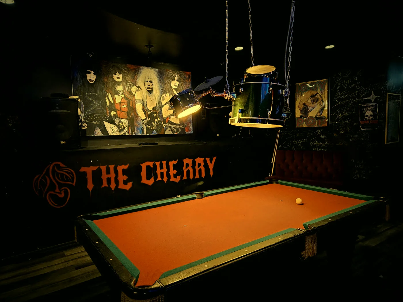 The Cherry pool table under the rock mural